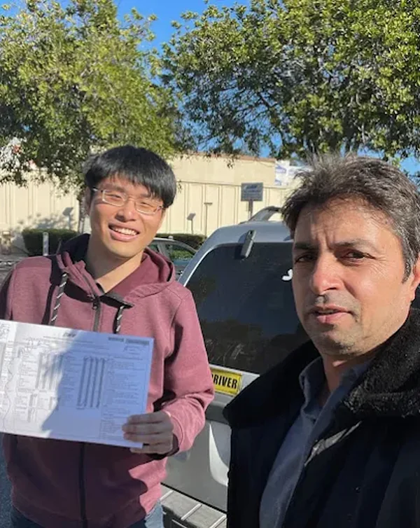 Javed, High Class Driving Instructor, with a student holding their passed California DMV drive test paperwork